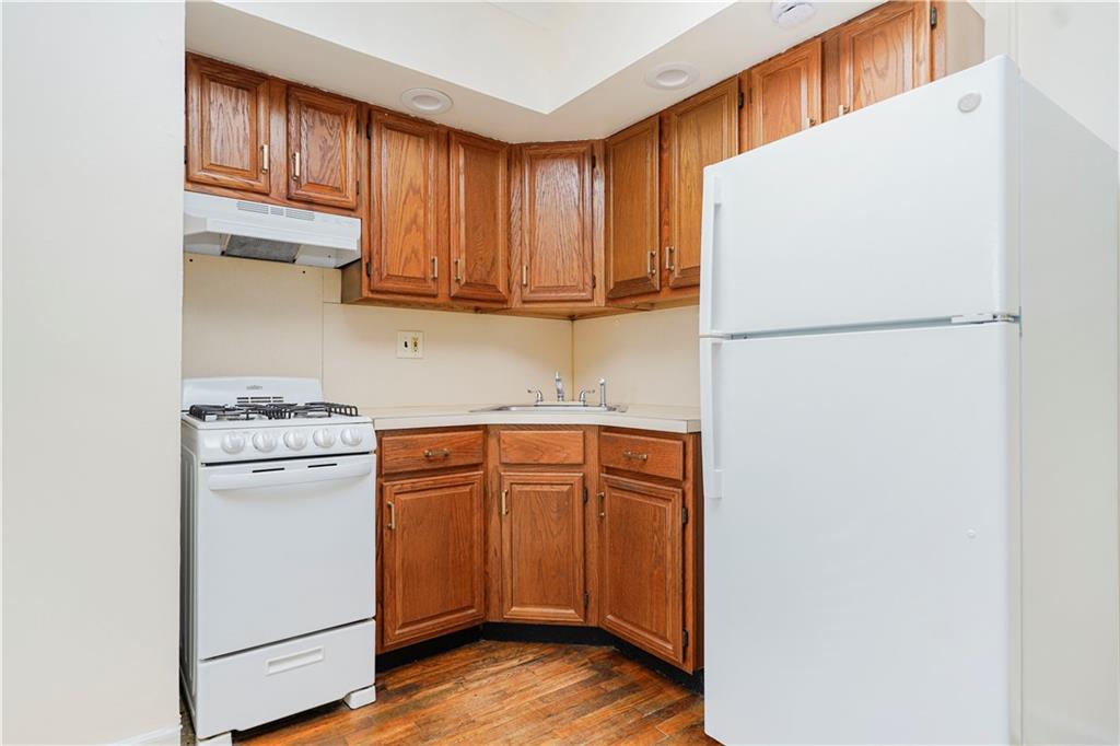 9430 Ridge Boulevard, Unit 6F Brooklyn, NY 11209 - Photo 8 of 15 a kitchen with stainless steel appliances granite countertop a refrigerator stove a sink and dishwasher