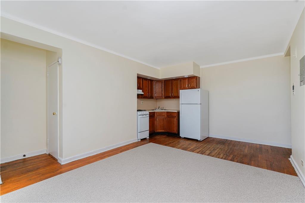 9430 Ridge Boulevard, Unit 6F Brooklyn, NY 11209 - Photo 9 of 15 a room with a refrigerator and cabinets