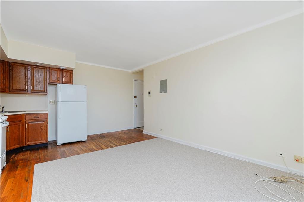 9430 Ridge Boulevard, Unit 6F Brooklyn, NY 11209 - Photo 10 of 15 a bedroom with a refrigerator and a stove top oven