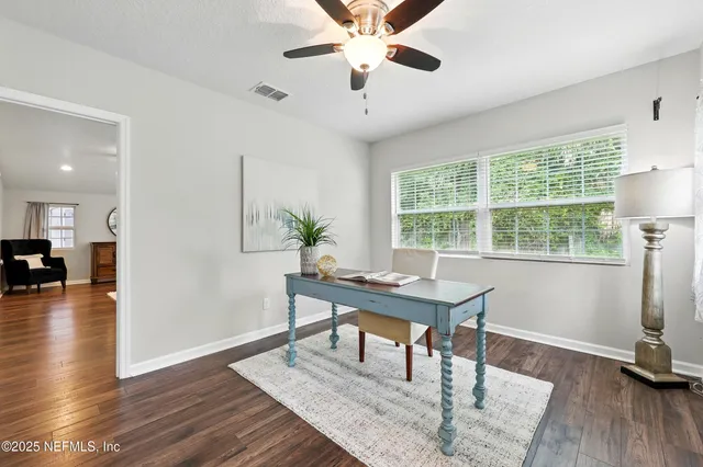 a workspace with furniture window and wooden floor