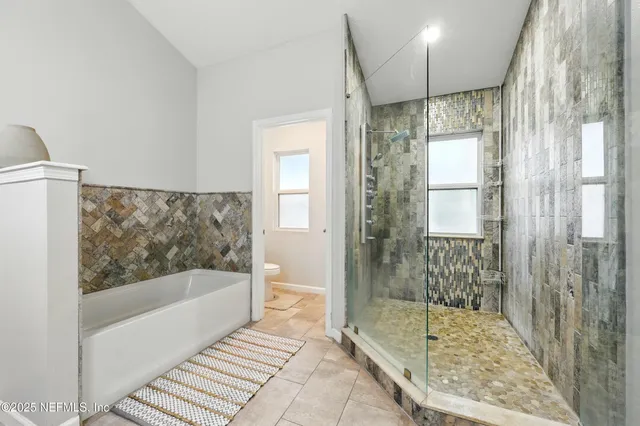 a bathroom with a bathtub and a shower