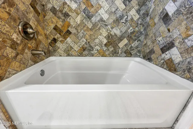 a white bath tub sitting in a bathroom