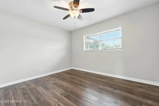 wooden floor in an empty room with a window