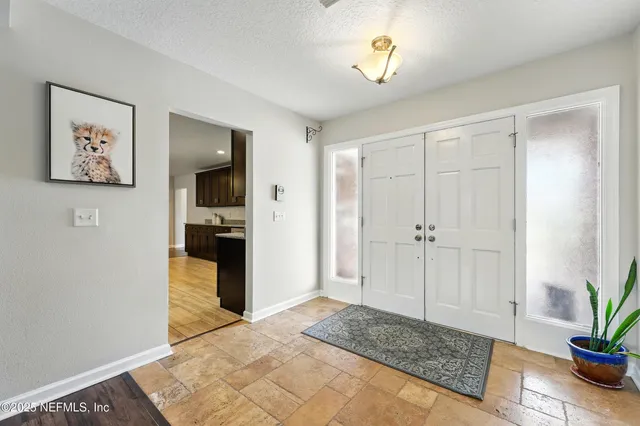 a spacious bedroom with a bed and a chandelier