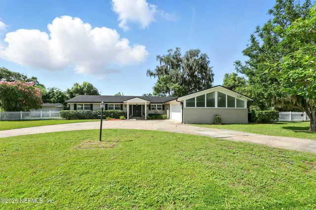 a house with swimming pool in front of it