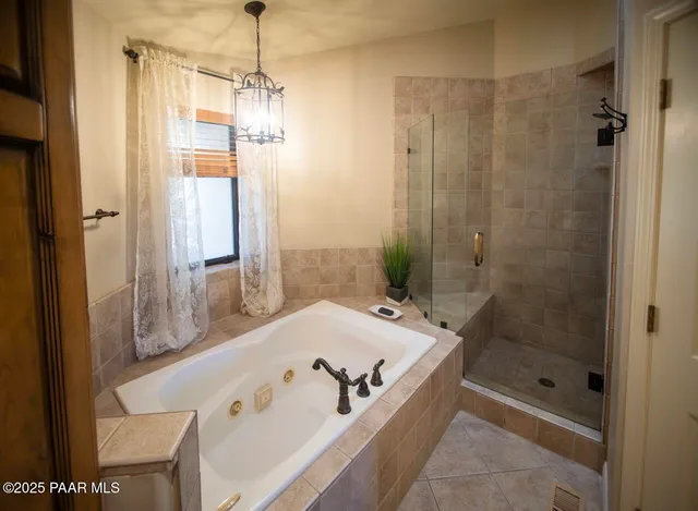 a bathroom with a tub and a shower