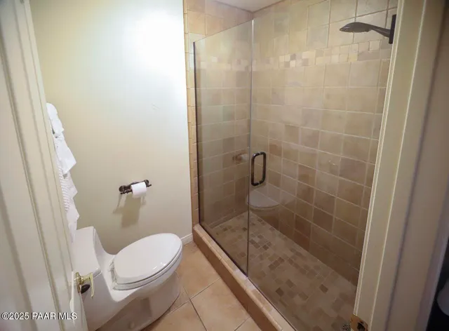 a bathroom with a shower a toilet and a sink