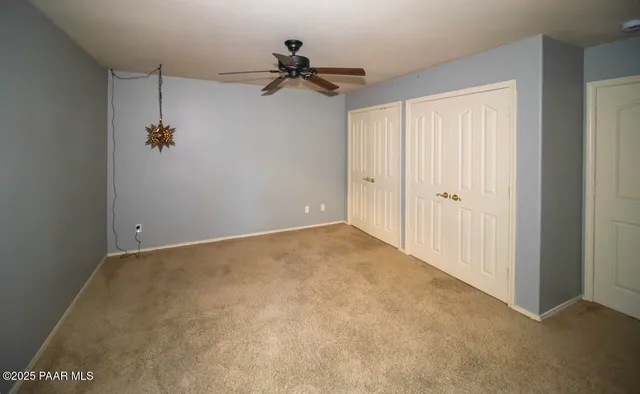 a view of a room with a ceiling fan