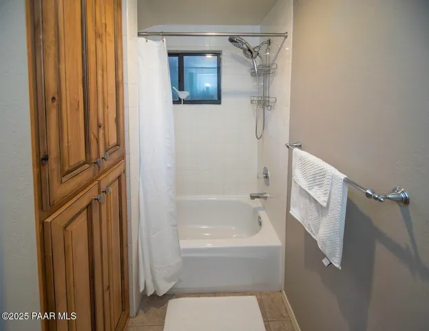 a bathroom with a tub and a shower