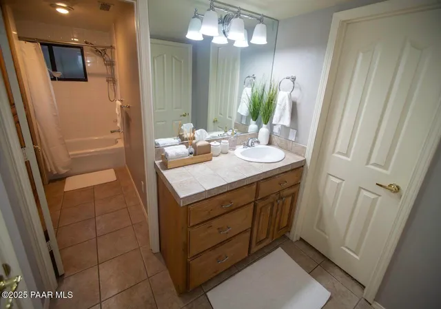 a bathroom with a sink a mirror and a shower