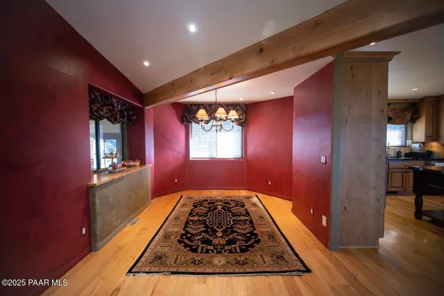 a view of a hallway and a livingroom with furniture