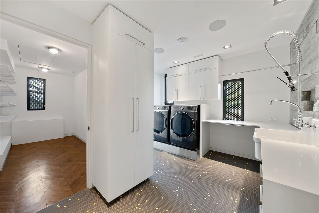 123 Hillcrest Road Raleigh, NC 27605 - Photo 20 of 30 quartz counters with waterfall treatments, scullery sink and sprayer, walk in linen closet. Penny tile and herringbone oak floors make even the laundry a pleasureable experience second floor laundry room