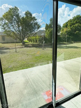 a view of an empty room and a window