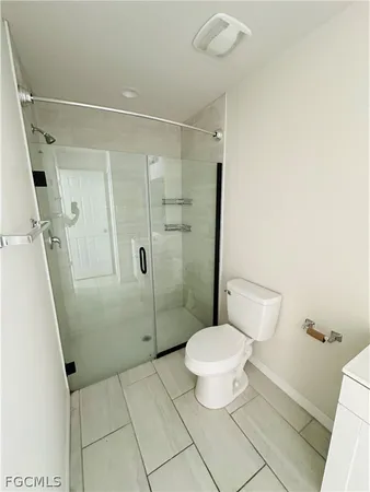 a bathroom with a toilet and a shower