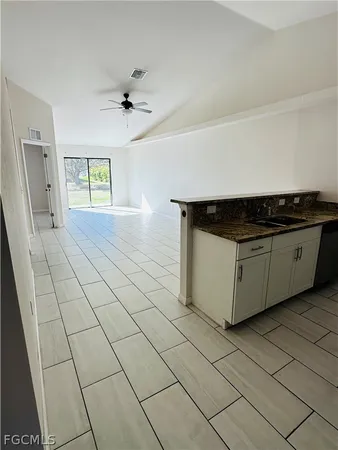 a kitchen with stainless steel appliances a refrigerator sink and microwave