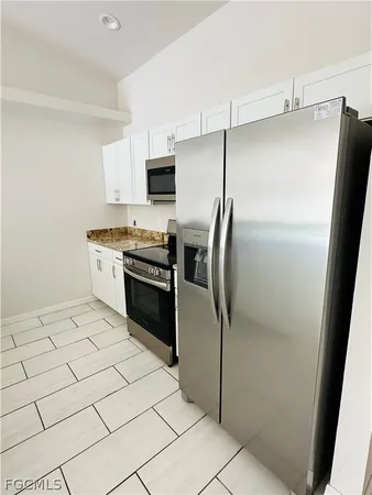 a kitchen with stainless steel appliances kitchen island a stove a sink and a refrigerator