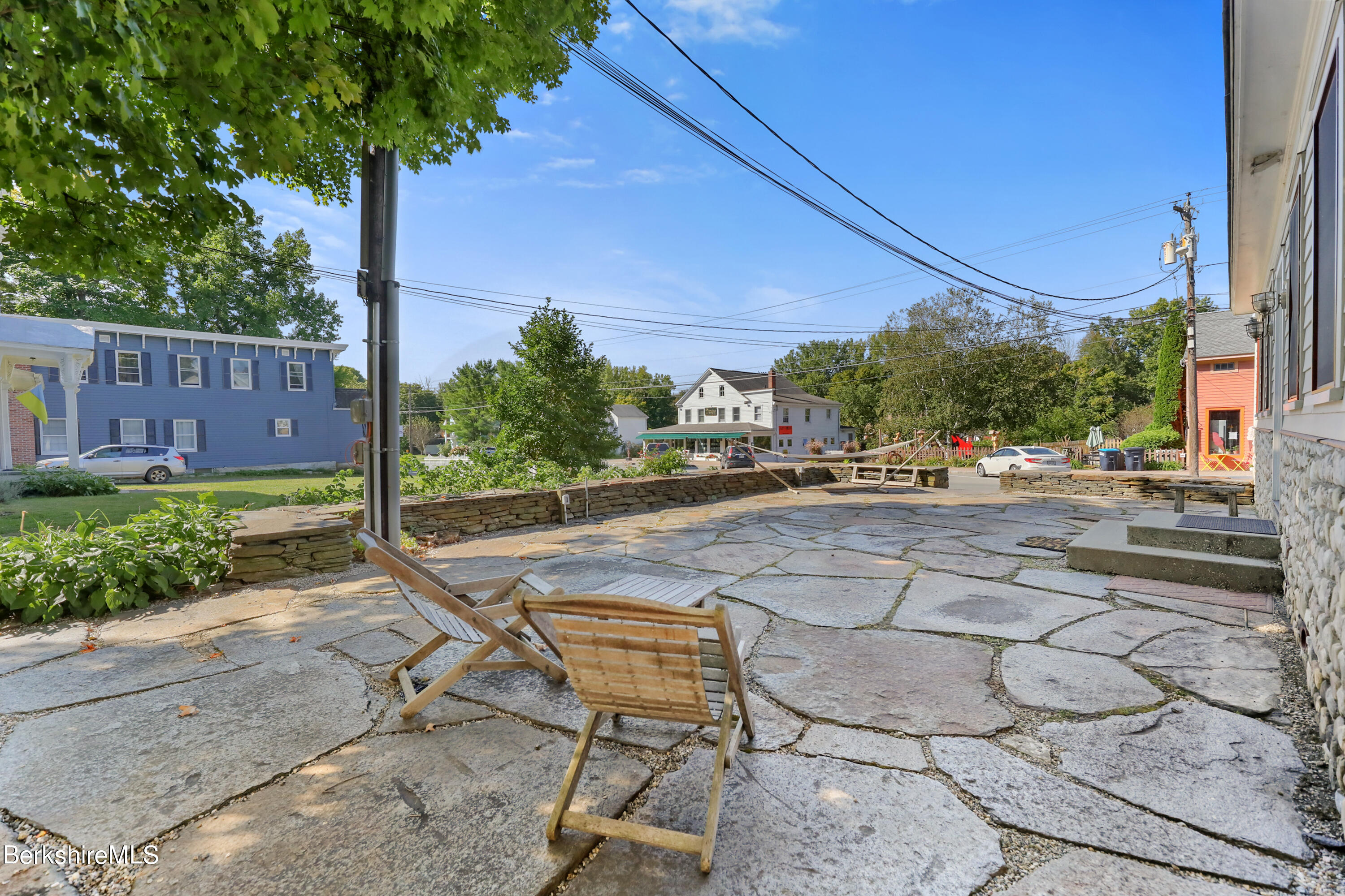 29 Main Street West Stockbridge, MA 01266 - Photo 7 of 51 a view of a patio with a table and chairs under an umbrella