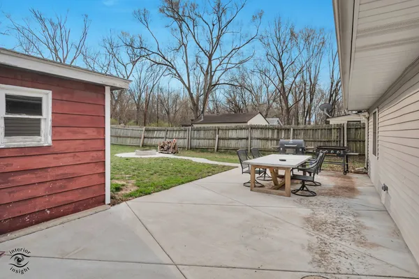 a view of outdoor space with table and chairs