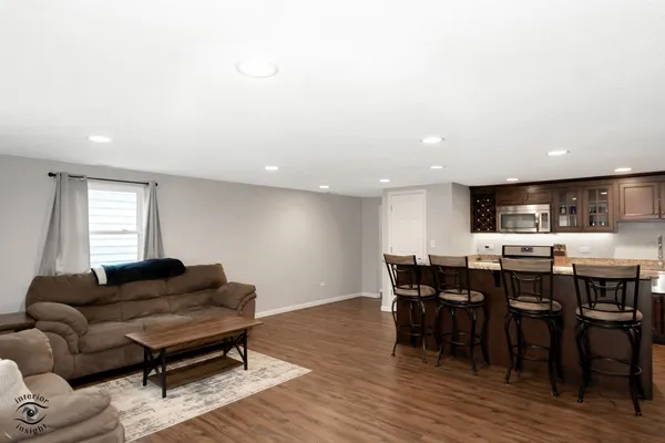 a living room with furniture a dining table and kitchen view