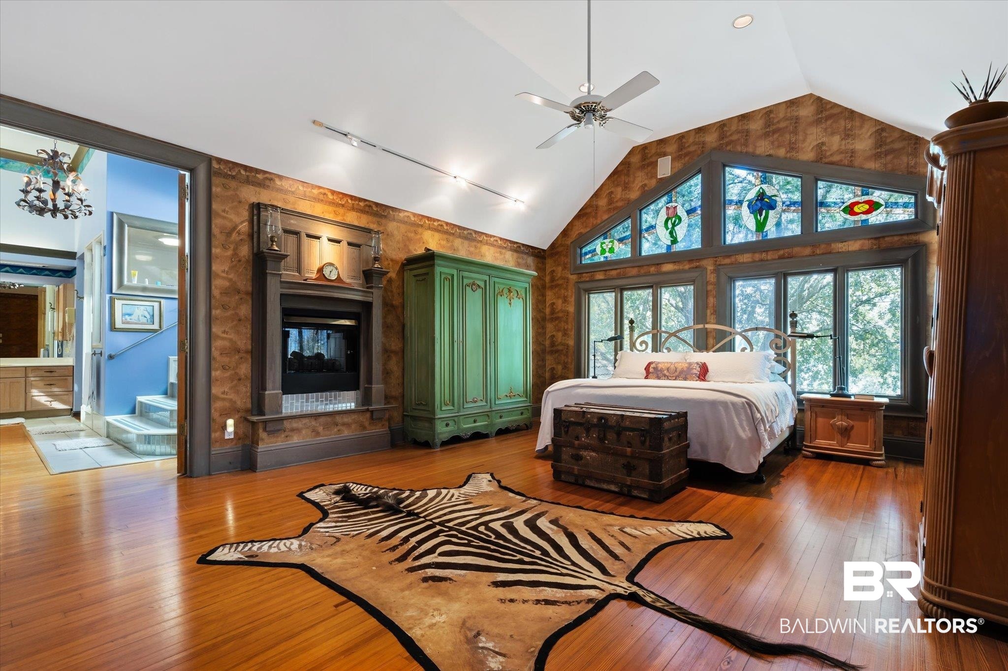 3325 Riviere Du Chien Road Mobile, AL 36693 - Photo 40 of 71 Bedroom with ceiling fan, connected bathroom, lofted ceiling, and wood-type flooring