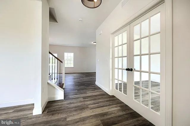 a view of an entryway with wooden floor