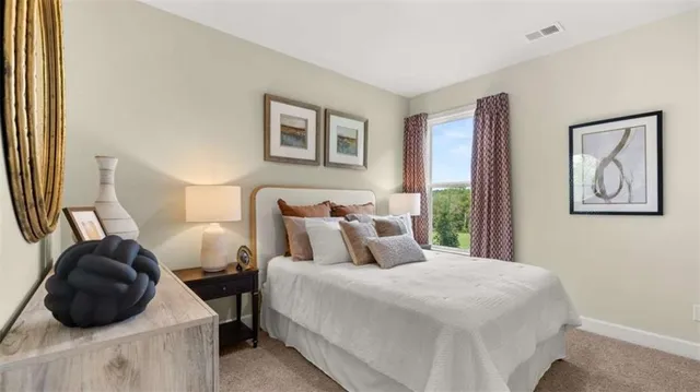 a bedroom with bed and a large mirror