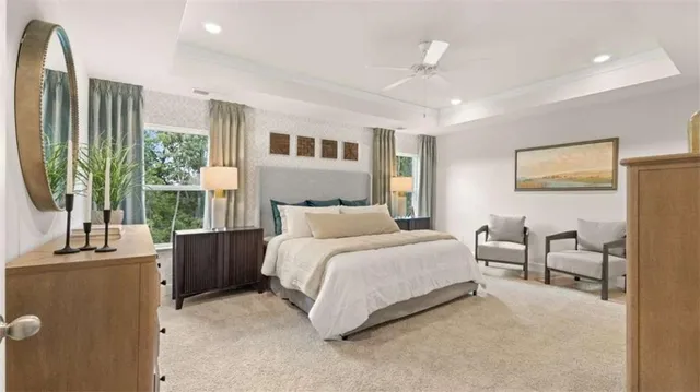 a bedroom with furniture and a large window