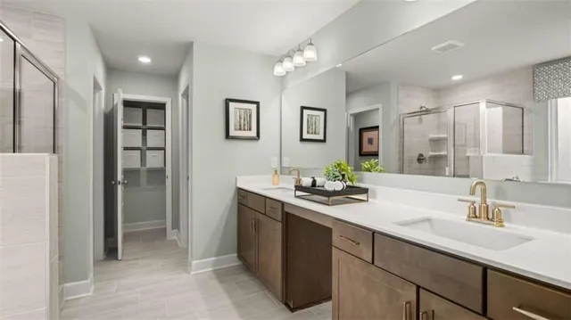 a bathroom with a sink double vanity and a shower