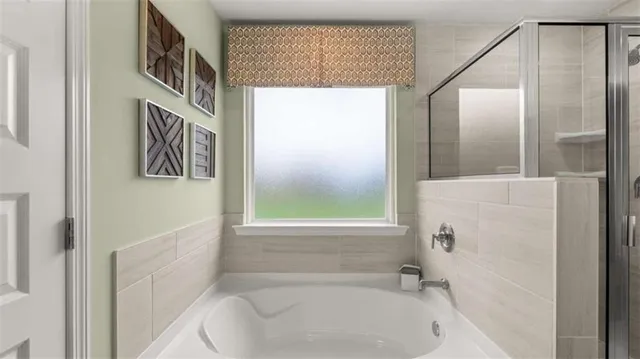 a bathroom with a bathtub and a shower