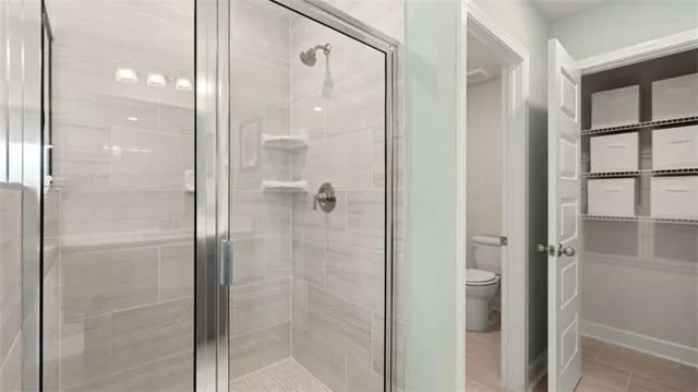 a bathroom with a glass shower door