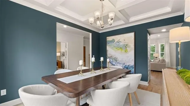 a view of a dining room with furniture a chandelier and wooden floor