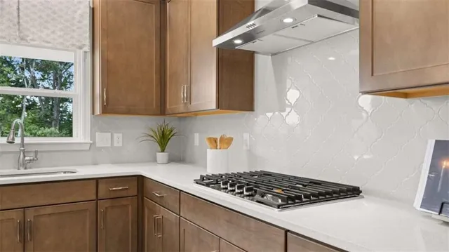a kitchen with stainless steel appliances granite countertop a sink stove and cabinets