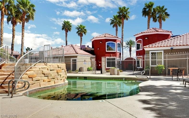 4730 East Craig Road, Unit 2102 Las Vegas, NV 89115 - Photo 12 of 13 A refreshing pool with elegant stone accents and surrounding palm trees provides an ideal oasis.