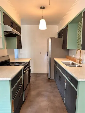 a kitchen with a stove and a refrigerator