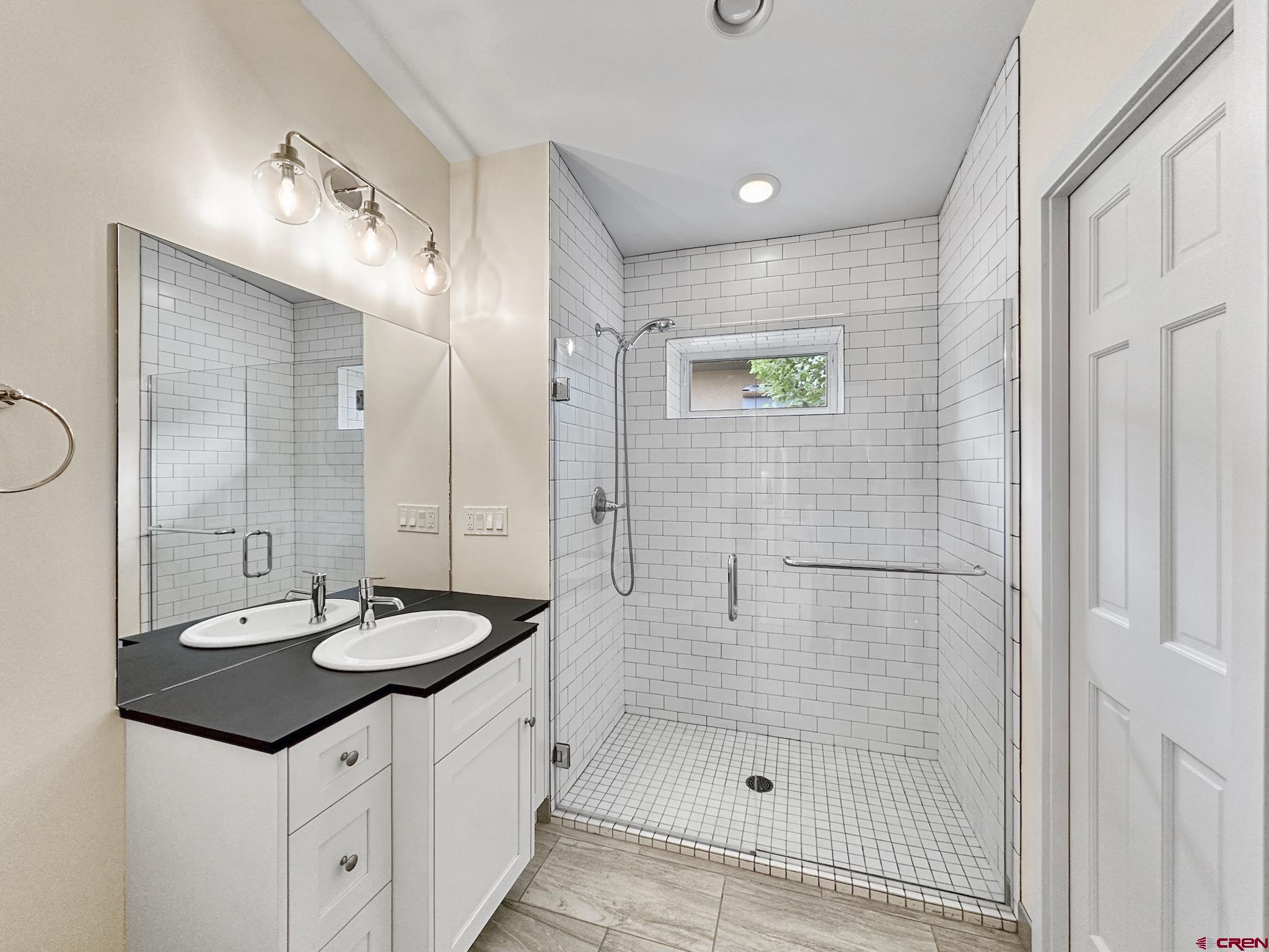 1200 3rd Street, Unit 6 Paonia, CO 81428 - Photo 17 of 34 a bathroom with a sink a shower and a mirror