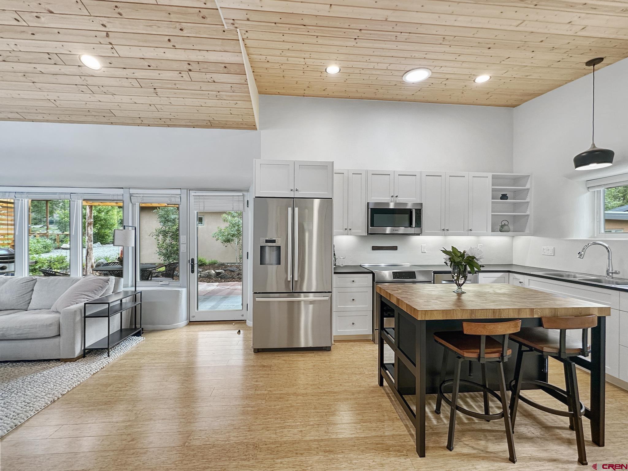 1200 3rd Street, Unit 6 Paonia, CO 81428 - Photo 24 of 34 a kitchen with stainless steel appliances granite countertop a table chairs stove and refrigerator