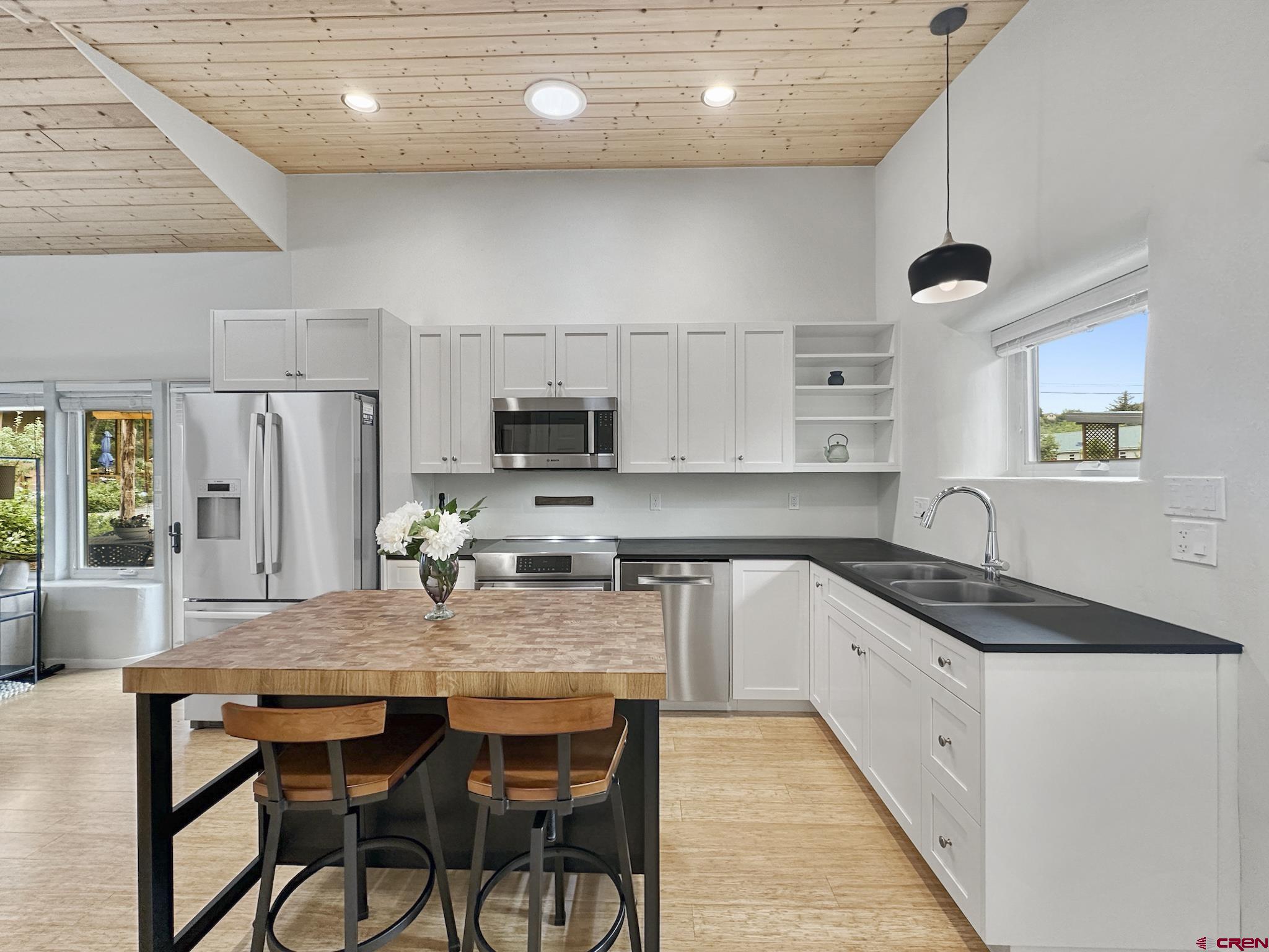 1200 3rd Street, Unit 6 Paonia, CO 81428 - Photo 5 of 34 a kitchen with granite countertop a stove a sink and a refrigerator