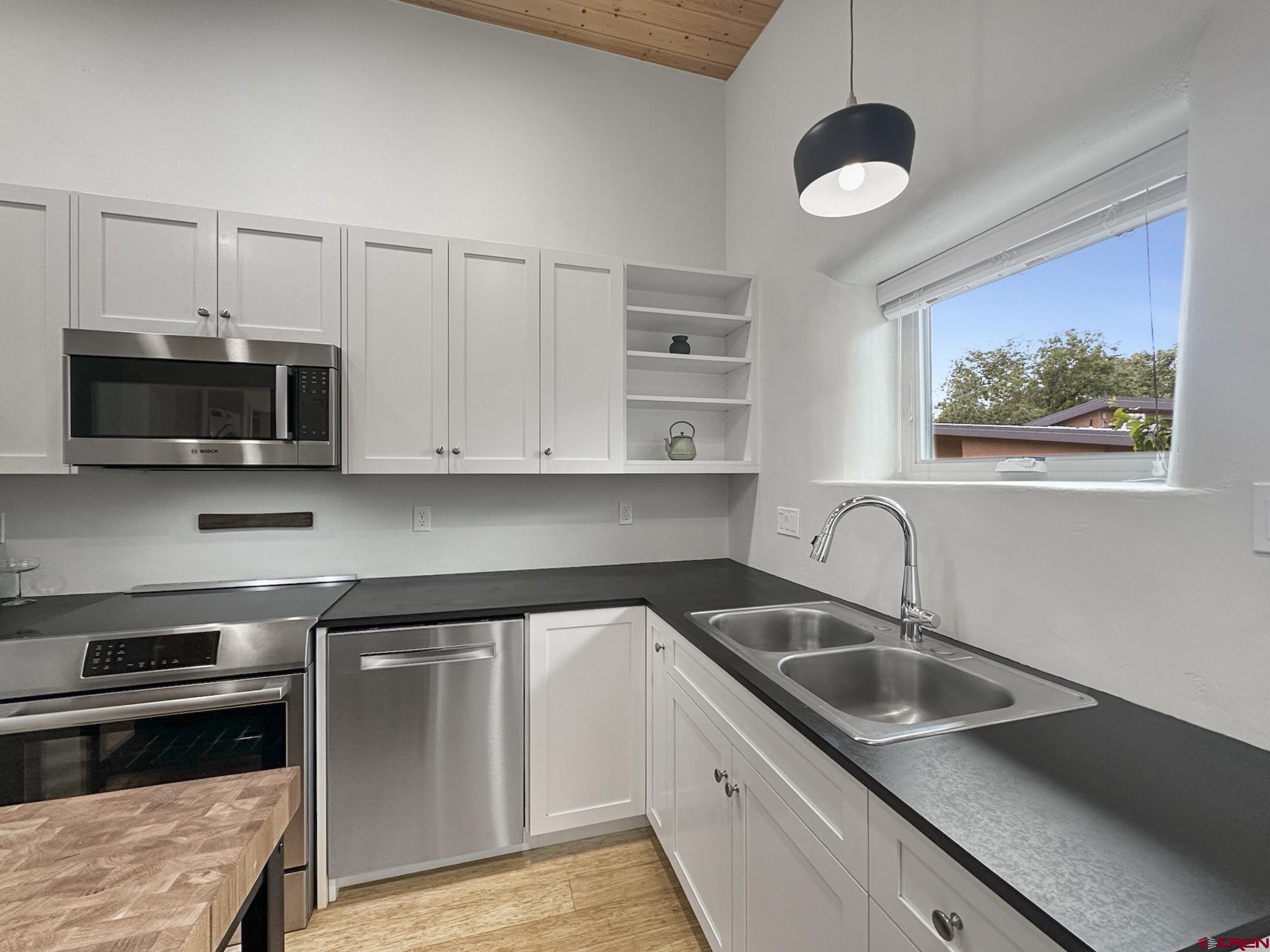 1200 3rd Street, Unit 6 Paonia, CO 81428 - Photo 8 of 34 a kitchen with stainless steel appliances a sink a stove and microwave