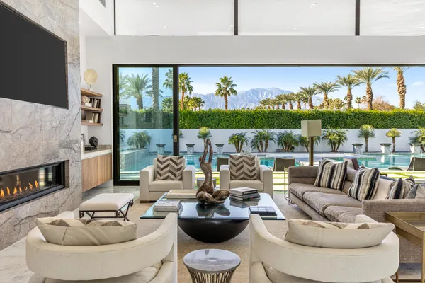a living room with furniture and a floor to ceiling window