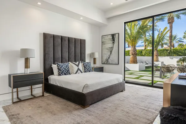 a bedroom with a bed and a night stand