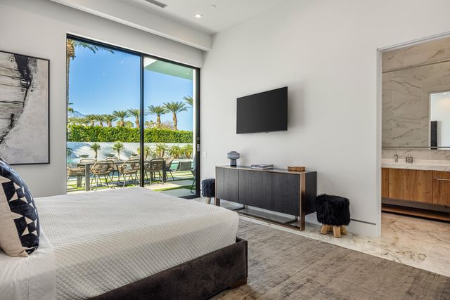 a bedroom with a bed and a flat screen tv