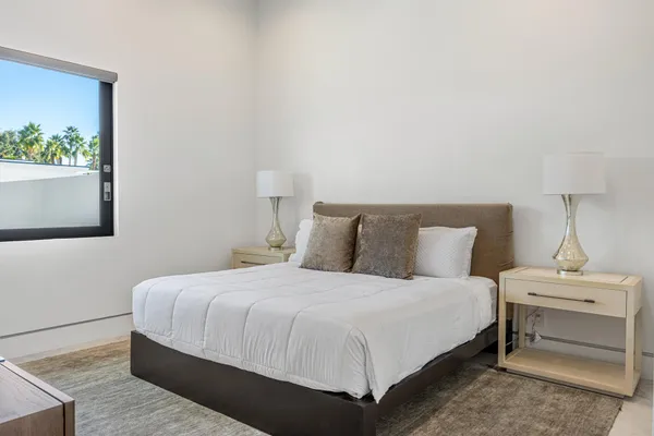 a bedroom with a bed and a window