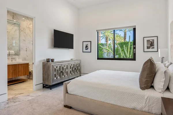 a bedroom with a bed and a flat screen television
