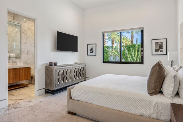 a bedroom with a bed and a flat screen television