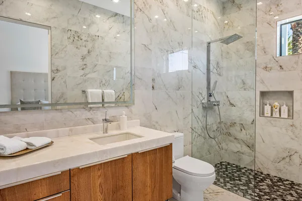 a bathroom with a sink toilet and shower