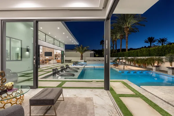 a view of a patio with swimming pool table and chairs