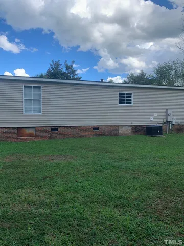 a view of a backyard with table and chairs