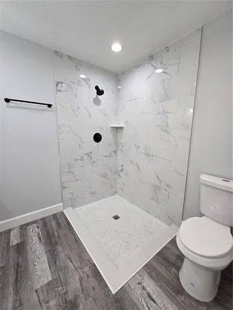 a bathroom with a toilet and a shower