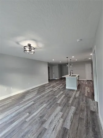 a view of a living room a kitchen and a chandelier