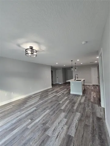 a view of a living room a kitchen and a chandelier